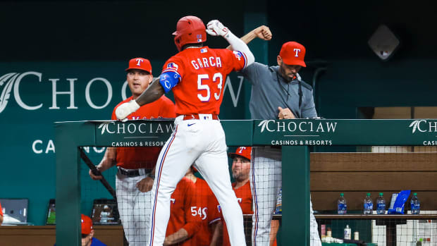 Jun 24, 2022; Arlington, Texas, USA; Texas Rangers center fielder Adolis Garcia (53) celebrates with Texas Rangers manager Chris Woodward (8) after hitting a home run during the sixth inning against the Washington Nationals at Globe Life Field. Mandatory Credit: Kevin Jairaj-USA TODAY Sports